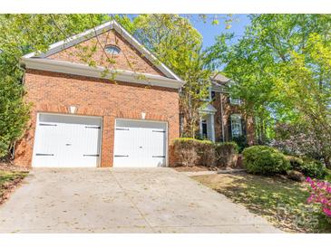Charming brick home boasts an attached two-car garage and beautifully landscaped front yard at 19113 Southport Dr, Cornelius, NC 28031