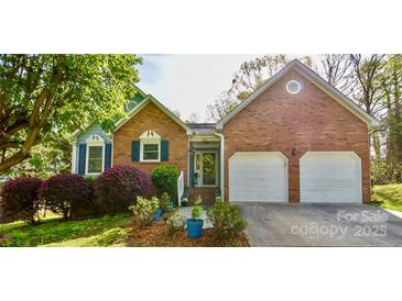 Charming brick home featuring an attached two-car garage, manicured lawn, and inviting front entrance at 2731 Bishopton Pl, Charlotte, NC 28216