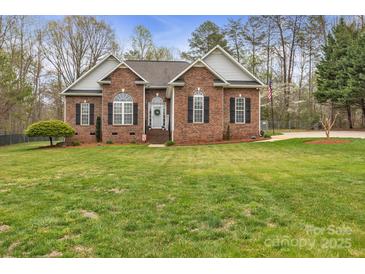 Charming brick home featuring a well-manicured lawn, an inviting entrance, and tasteful landscaping at 3565 Laboratory Rd, Lincolnton, NC 28092