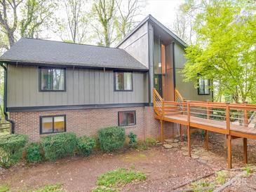 Unique home with wooden walkway leading to the front door and a combination brick and paneled facade at 615 Ridgeway Dr, Belmont, NC 28012