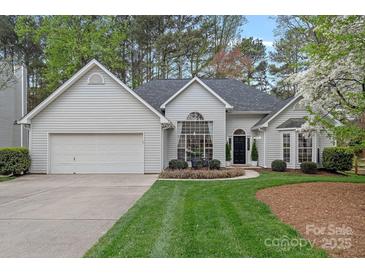 Charming home featuring manicured front lawn, mature trees, and an attached two-car garage, offering curb appeal at 9118 Pine Springs Ct, Huntersville, NC 28078