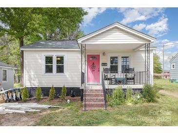 Charming home featuring a pink door, front porch, and landscaped yard at 206 Friedheim Rd, Rock Hill, SC 29730