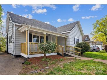 Charming single-story home featuring a covered porch and well-maintained front yard at 221 N Davis Ave, Newton, NC 28658