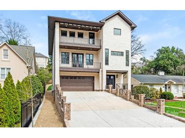 Stunning three-story home with a brick facade and multiple balconies at 2909 Hanson Dr, Charlotte, NC 28207