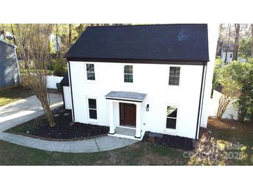 Charming two-story home featuring a white brick facade, black roof, and a welcoming front entrance at 314 Bass Ln, Charlotte, NC 28270