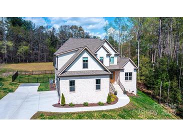 Beautiful brick home with a well-manicured lawn and professional landscaping at 112 Whitman Ct # 275, Taylorsville, NC 28681