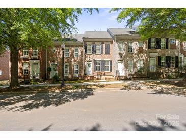 Charming brick townhomes featuring well-maintained landscaping and classic architectural details at 164 Singleton Rd, Mooresville, NC 28117