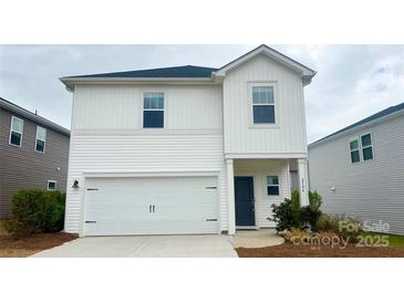 Charming two-story home featuring white siding, a front-entry garage and a covered front porch at 2104 Morgan Hill Dr, Albemarle, NC 28001