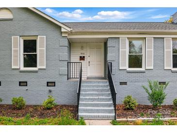 Charming blue painted brick home with a welcoming front entrance and well-manicured landscaping at 2416 Wendy Ln # 13, Gastonia, NC 28052