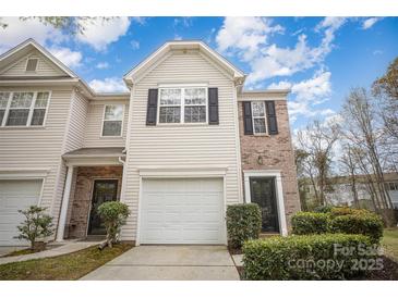 Charming townhome with a garage and well-maintained landscaping in a desirable neighborhood at 7445 Abigail Glen Dr, Charlotte, NC 28212