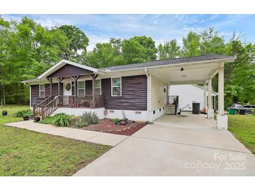 Charming single story home boasts a covered front porch and convenient carport perfect for outdoor living at 8301 Washington Blvd, Charlotte, NC 28262