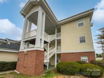 Inviting exterior view showcasing the building's architecture with covered stairways and manicured landscaping at 8929 Meadow Vista Rd, Charlotte, NC 28213