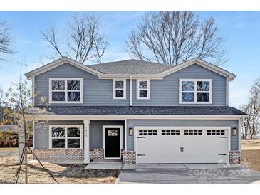 Charming two-story home with gray siding, a two-car garage, and meticulous brick-base detailing at 1034 Dooley Dr, Charlotte, NC 28227