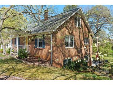 Charming two-story brick home with well-maintained landscaping and inviting front porch at 206 23Rd Nw St, Hickory, NC 28601