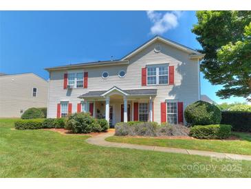 Charming two-story home featuring eye-catching red shutters and lush green landscaping at 3835 Mohawk Ct, Charlotte, NC 28215