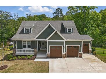 Inviting craftsman home with a three-car garage and manicured landscaping for stunning curb appeal at 4120 Spring Cove Way, Belmont, NC 28012