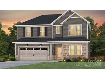 Charming two-story home featuring a two-car garage and a mix of siding and brick facade at 13756 Roderick Dr # 176, Huntersville, NC 28078
