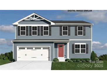 Charming two-story home featuring a two-car garage, red front door, and blue siding with black shutters at 169 Basildon St # 1012, Lancaster, SC 29720