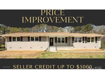 Charming single-story home with a brick facade, black shutters, and front lawn at 174 Maske Rd, Mount Gilead, NC 27306
