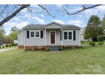 Inviting single-story home with a quaint front porch and manicured lawn, perfect for a cozy living experience at 1926 Coley Sw St, Concord, NC 28027
