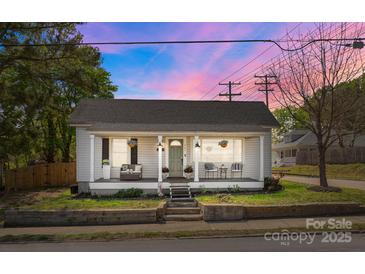 Charming single-story home with a welcoming front porch, perfect for relaxing and enjoying the neighborhood at 207 Kerr Nw St, Concord, NC 28025