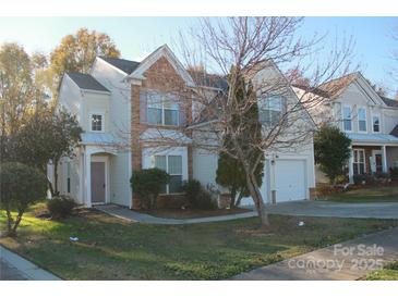 Inviting two-story home featuring stone accents, a manicured lawn, and an attached garage at 2125 Arbor Vista Dr, Charlotte, NC 28262