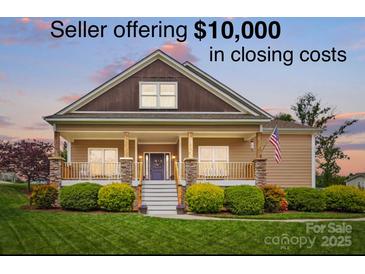 Charming one-story home featuring a covered porch, well-manicured lawn, and beautiful landscaping at 307 Jaida Ln, Oakboro, NC 28129