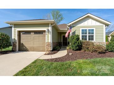 Charming home featuring a one car garage, stone accents, and an inviting covered porch at 314 Flat Rock Dr, Denver, NC 28037