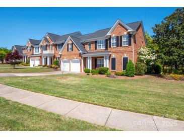 Charming brick home with black shutters, lush lawn, and two-car garage in a desirable neighborhood at 320 Falesco Ln, Matthews, NC 28105