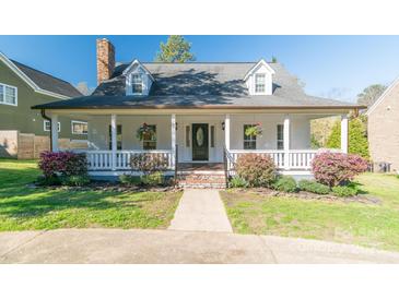 Charming home featuring a welcoming front porch, dormer windows, and manicured landscaping at 3921 Bon Rea Dr, Charlotte, NC 28226