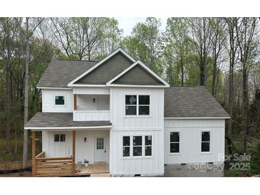 New two-story home featuring white board and batten siding, a gray roof, and a welcoming front porch at 4125 Hemingway Dr, Hickory, NC 28601