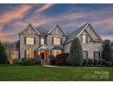 Beautiful two-story home with a well-manicured lawn and lush landscaping at 516 White Tail Ter, Waxhaw, NC 28173
