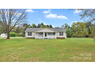 Charming ranch-style home with a spacious front yard, covered porch, and classic architectural details at 775 Bolick Rd, Fort Mill, SC 29707