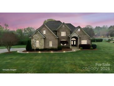 Charming, stone-accented home with manicured lawn and lush landscaping under a vibrant twilight sky at 1012 Harper Lee Dr, Newton, NC 28658
