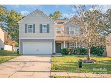 Charming two-story home with a well-manicured lawn and attached garage at 1219 Century Dr, Clover, SC 29710