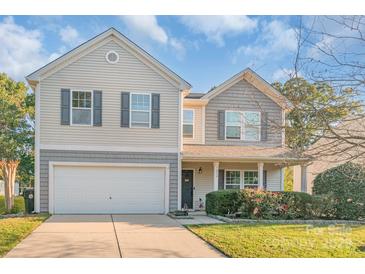 Inviting two-story home featuring a well-kept lawn and an attached two-car garage at 1219 Century Dr, Clover, SC 29710