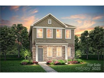 Charming two-story home with stone accents, a well-manicured lawn, and professionally landscaped flower beds at 15910 Parkside Crossing Dr # 318, Charlotte, NC 28278