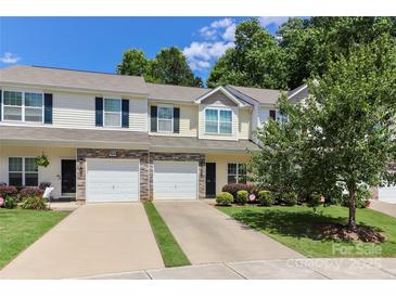 Inviting townhouse with stone accents, attached garage, and well-maintained front yard at 168 Limerick Rd # C, Mooresville, NC 28115