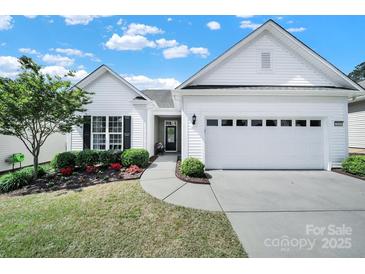 Charming single-story home with manicured lawn, mature landscaping, and attached two-car garage at 5039 Folly Ln, Fort Mill, SC 29707