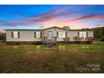 Charming single-story home featuring a well-maintained front yard under a colorful sky at 5110 Old Still Ln, Bessemer City, NC 28016