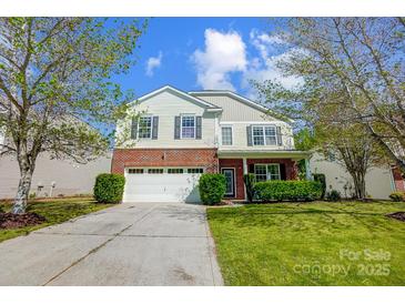Charming two-story home with a brick and vinyl exterior, attached garage, and well-maintained lawn at 517 Bertram Rd, Fort Mill, SC 29708