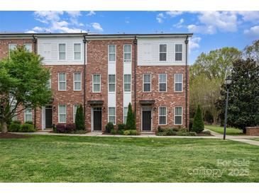 Attractive brick townhome with manicured lawn and landscaping at 791 Seigle Point Dr, Charlotte, NC 28204