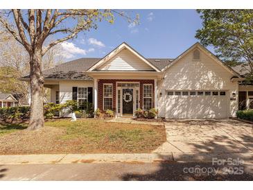 Charming single-story home with brick and white siding, attached garage, and well-manicured lawn at 8603 Bookwalter Ct, Charlotte, NC 28277