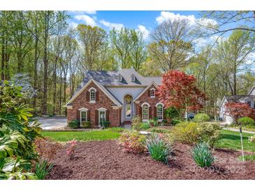 Charming brick home with manicured lawn and lush landscaping at 125 Cove Creek Loop # 18, Mooresville, NC 28117