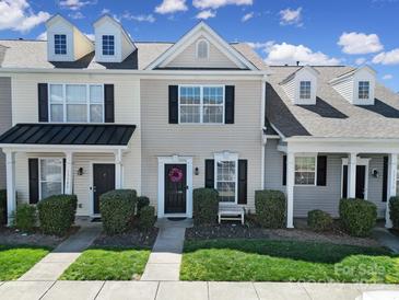 Charming townhome featuring a well-maintained lawn, classic architectural details, and a welcoming entrance at 13376 Calloway Glen Dr, Charlotte, NC 28273