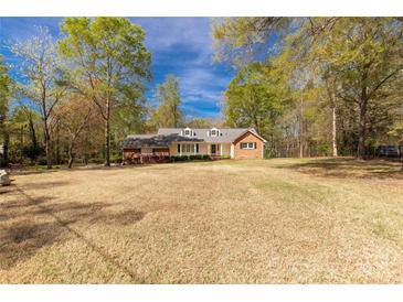 Ranch-style home showcasing a spacious front yard and traditional brick and siding exterior at 605 Ottawa Dr, Rock Hill, SC 29732