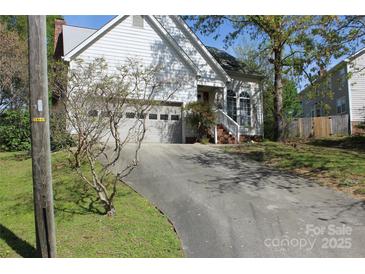 Charming home with an attached garage and an inviting entrance, complemented by a well-maintained driveway at 9915 Lottie Ln, Charlotte, NC 28262