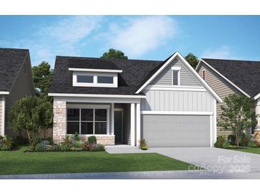 Charming home showcasing a mix of stone and siding, complemented by a manicured lawn and inviting curb appeal at 1131 Meander Ln, Waxhaw, NC 28173