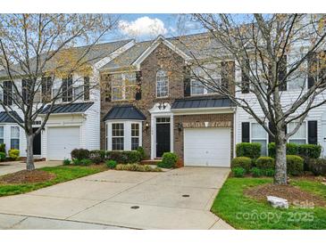 Charming brick townhome with a well-manicured lawn and attached one-car garage at 125 Snead Rd # 60, Fort Mill, SC 29715