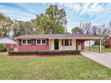 Charming brick home featuring a well-maintained front yard, black shutters, and an attached carport at 140 Mickle Ct, Rock Hill, SC 29732